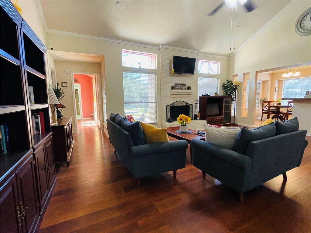 View of den with high ceiling and plenty of natural light.