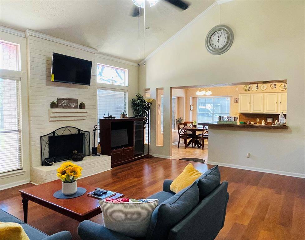Den with a gas fireplace opens towards the breakfast bar, breakfast room and kitchen.
