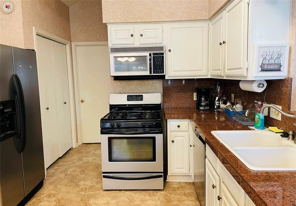 Refrigerator is included with leasing the property. A different angle of the kitchen. The double basin sink is a nice size.