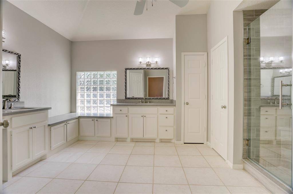 The primary suite has been customized with two separate sinks, two closets, and plenty of storage space.