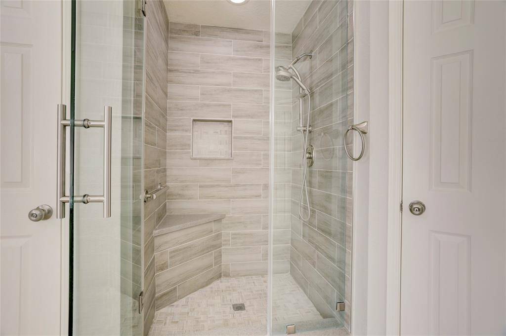 This shower has been customized and is oversized with a comfy bench.
