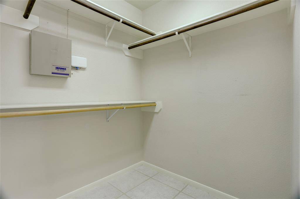 This is one of two identical closets in this primary suite.