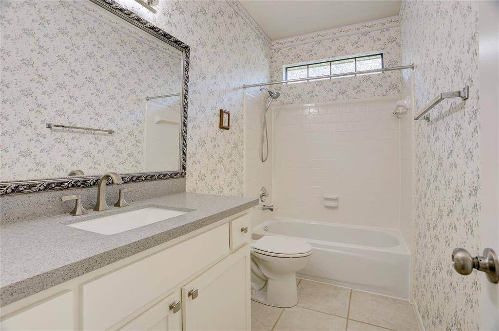 The full guest bathroom is spacious with lots of storage.