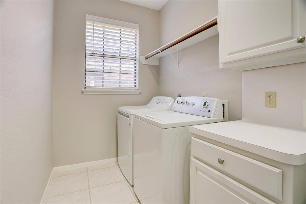 This laundry room is enormous, with lots of counter space and storage.