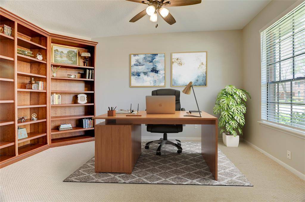 The office/extra bedroom is through the French doors on the right and features custom built-in real wood bookshelves.