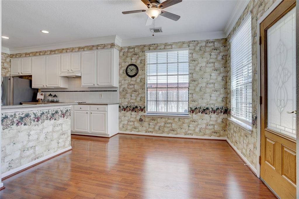 As you enter the breakfast room, you have plenty of space for a large dining table and bar stools.