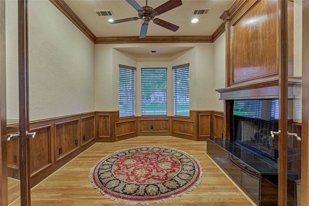 Cozy sitting room with a warm fireplace, perfect for relaxation or use as a home office.