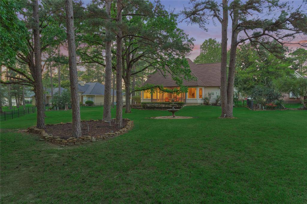 The picturesque backyard has a peaceful setting that expands on two lots for added privacy and peaceful living.
