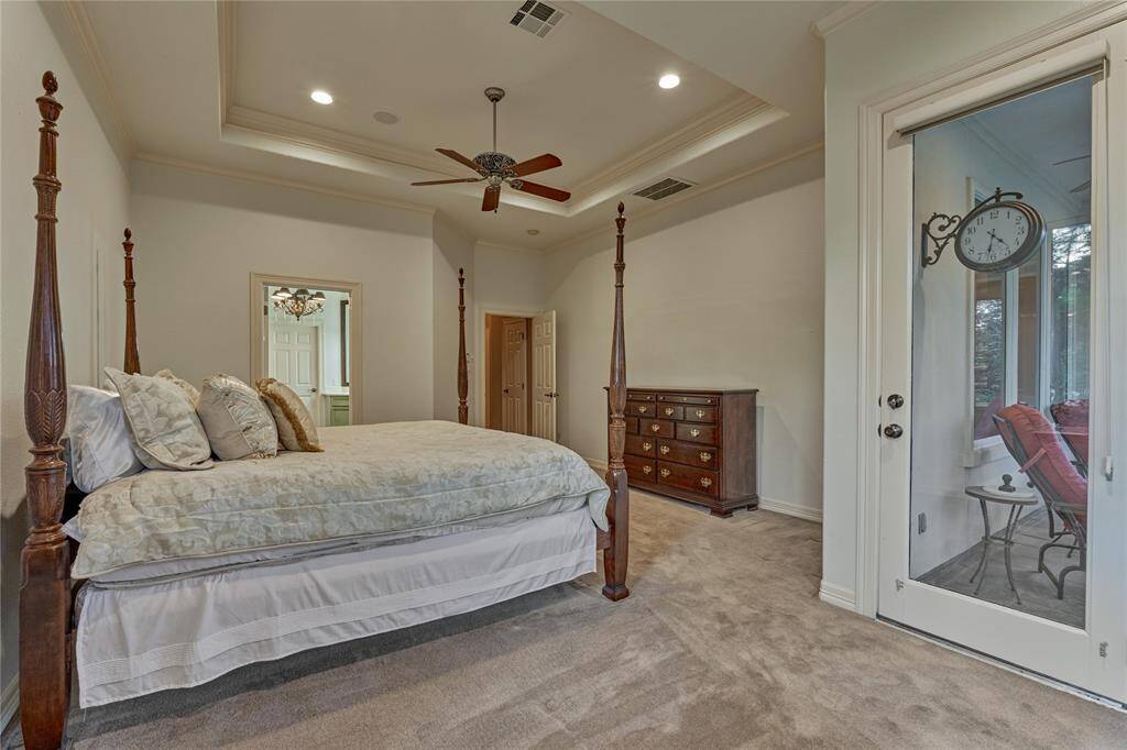 Spacious owner's retreat with access to the screened-in patio.