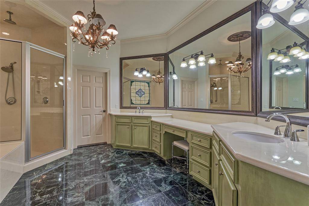 Luxurious ensuite with dual sinks, vanity, walk-in shower, and a soaking tub for ultimate relaxation.