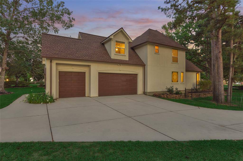 Extended driveway and two-car garage with golf cart bay.