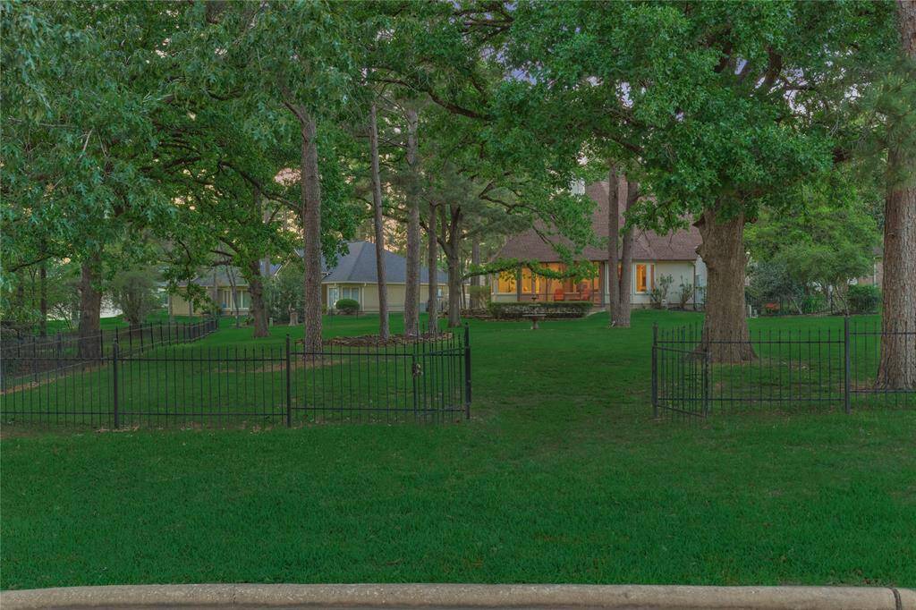 Lovely wrought-iron fencing compliments the tranquil outdoor setting.