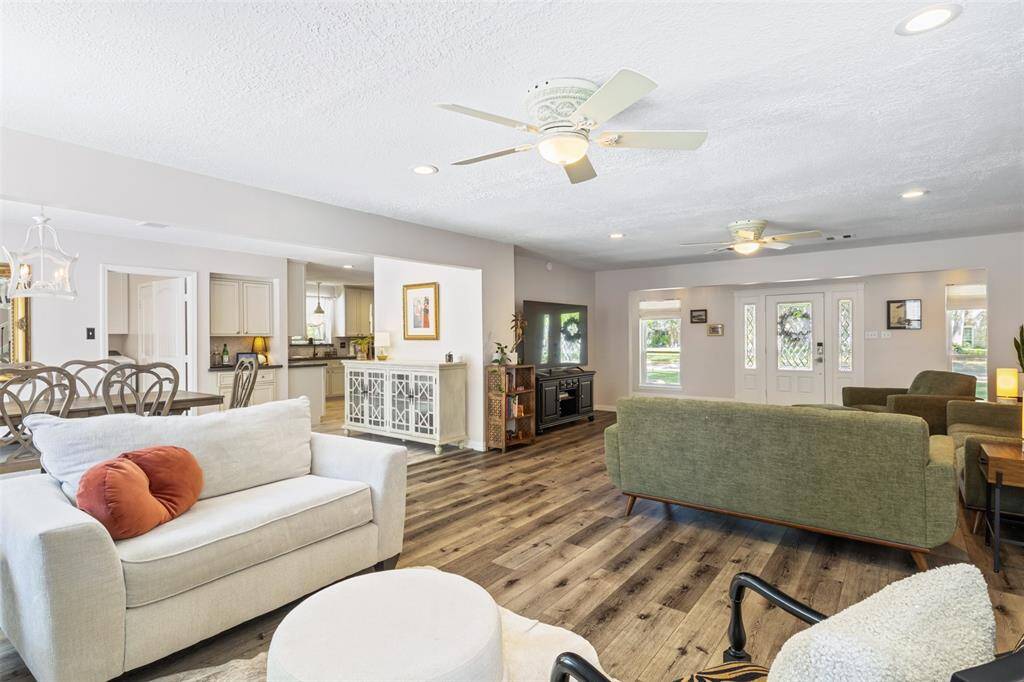 Bright and open-concept living area seamlessly connects to the dining area and kitchen, offering a welcoming and functional layout for entertaining.