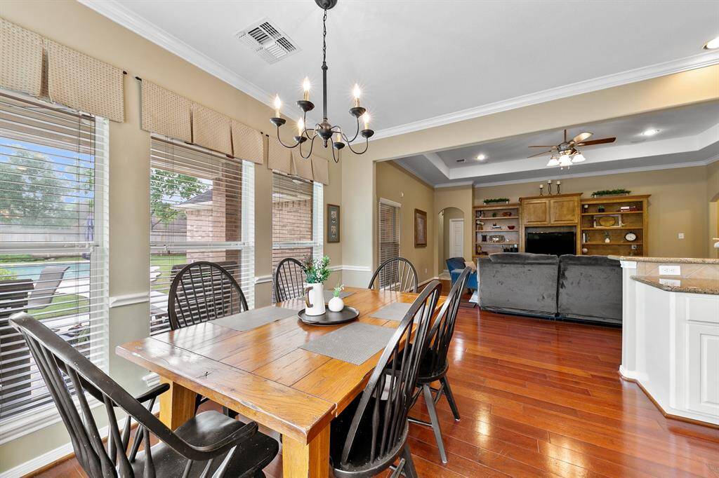 Breakfast room is directly open to the family room and has large widows to enjoy the view of the serene pool.