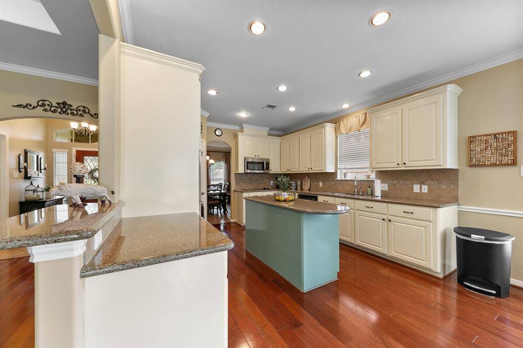 The kitchen is a chefs dream with lots of prep space, a large island, and plenty of cabinetry for storage.
