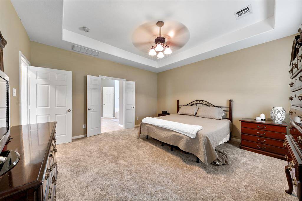 Primary bedroom with beautiful tray ceiling.
