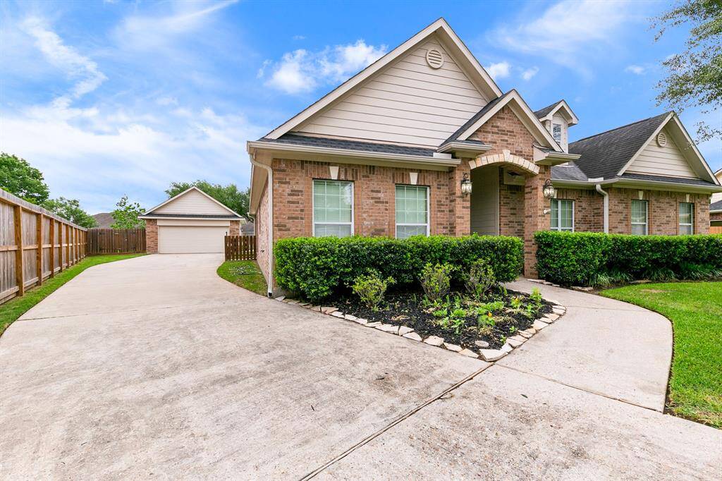 The detached garage sits at the back of the elongated driveway.