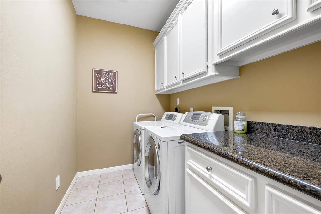 Laundry room with cabinets for storage and coutertops to fold or iron on.