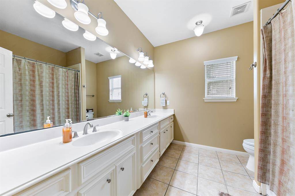 Secondary bath with double sinks.