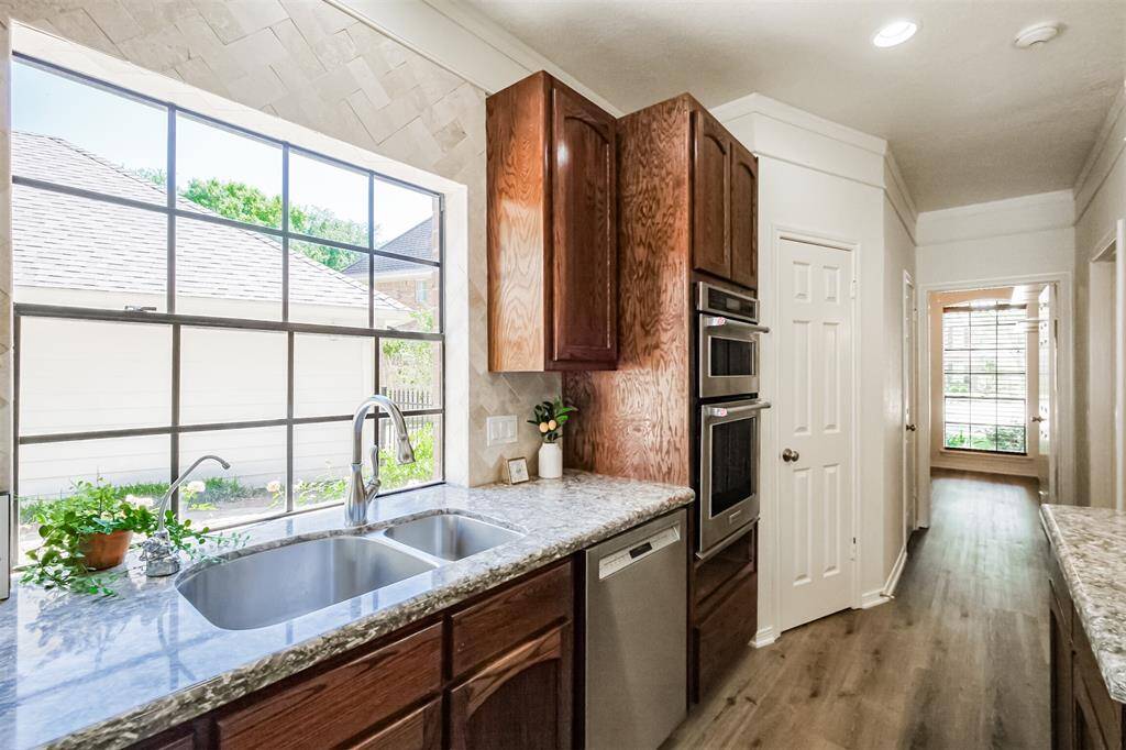 Double stainless farmhouse sink with a view of the great outdoors.