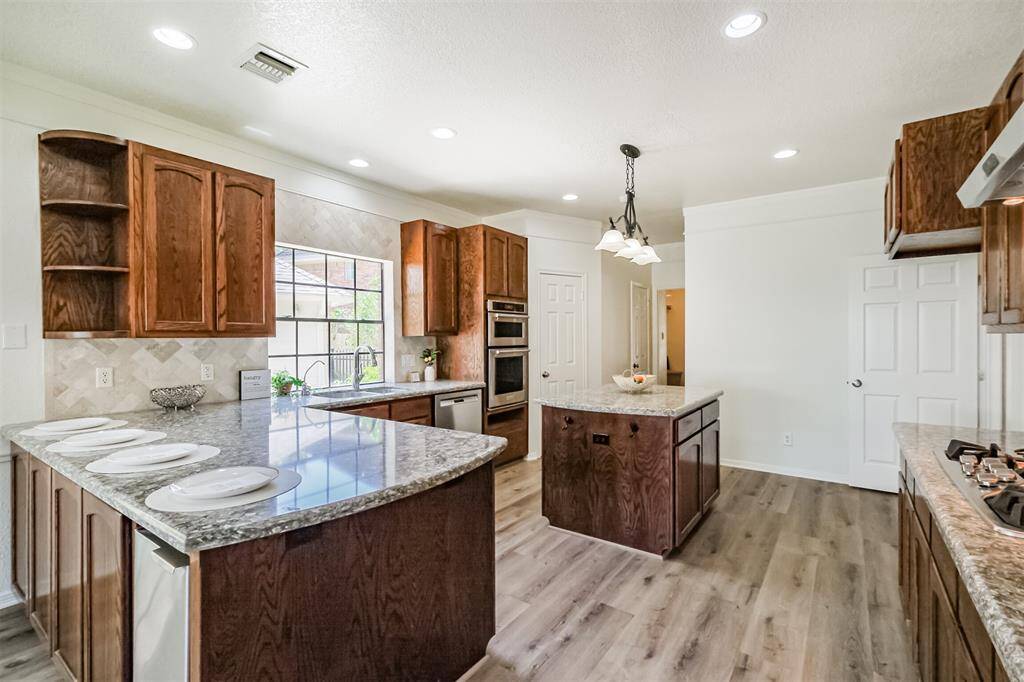 Gleaming quartz counters shine under the recessed lighting.