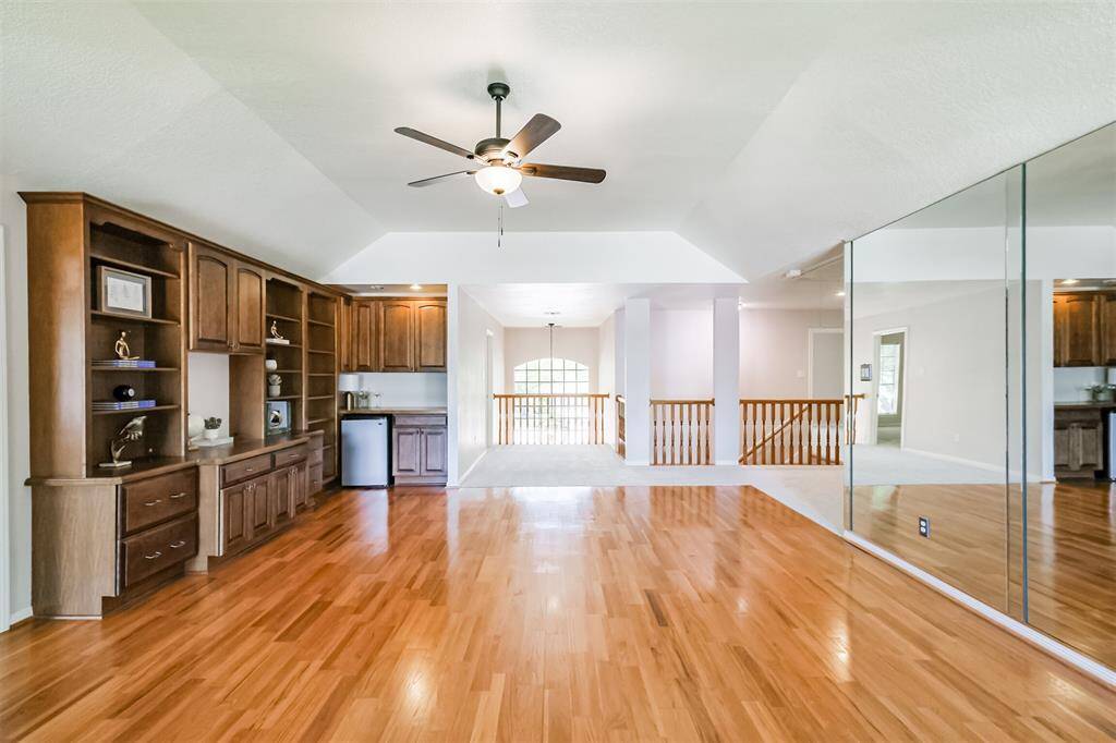 HUGE gameroom on the second floor with hardwoods. With its mirrored wall this space is ideal for yoga, a workout space or for a budding ballet dancer!