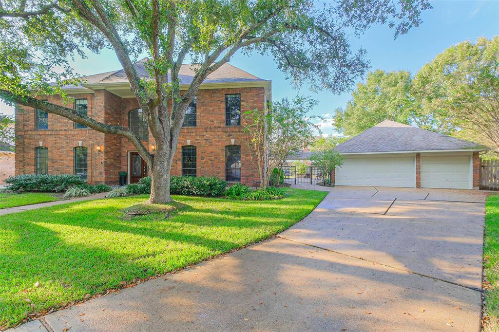 Long, wide driveway provides ample parking. Note gate to the left of the garage to ensure safe play for pets and children in the large backyard.