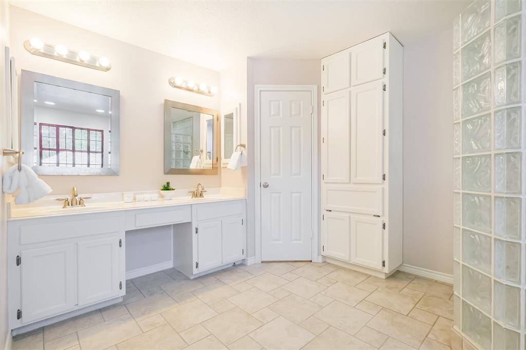 The second primary ensuite has a double vanity, walk in closet and extra cabinet storage space.