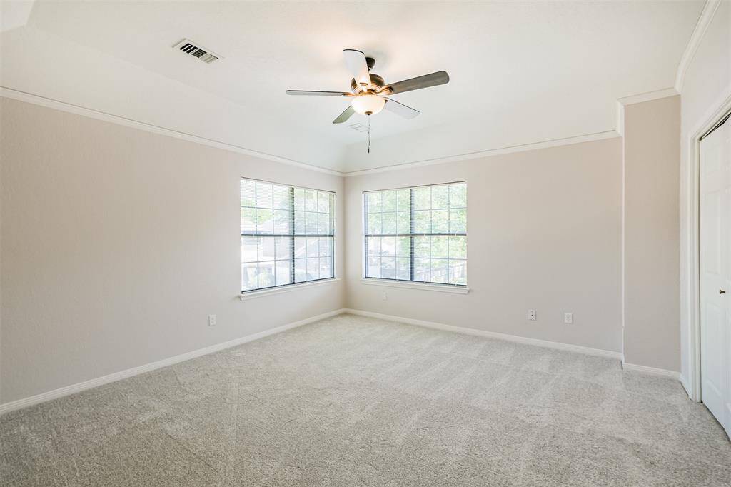 The fourth bedroom on the second floor has two corner windows overlooking the mature trees in the back yard.