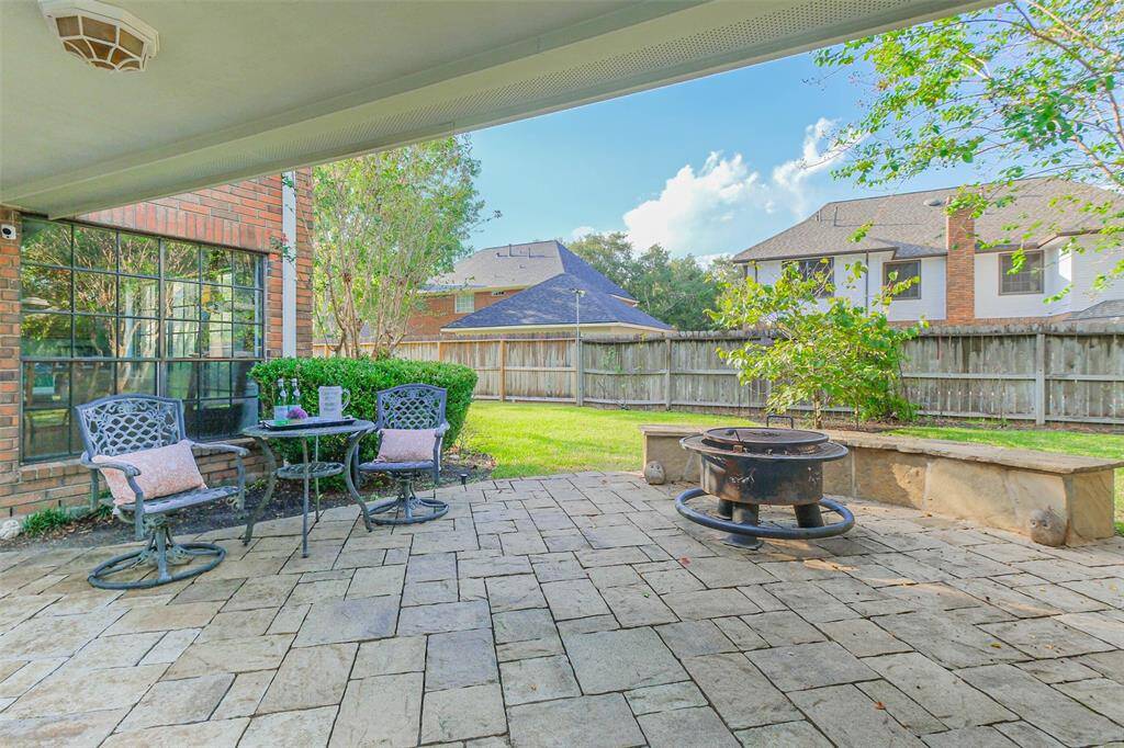 Peaceful covered shady paved patio outside the kitchen - perfect for morning coffee al fresco or for toasting smores on a firepit.