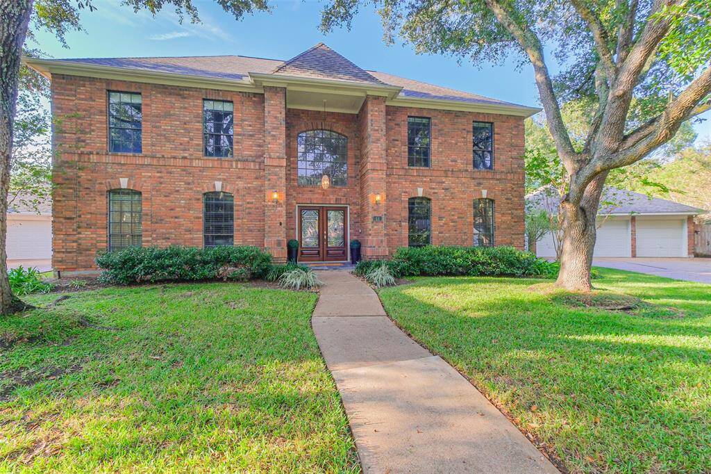 Mature trees frame this gorgeous home with attractive two story porch and double leaded glass doors.