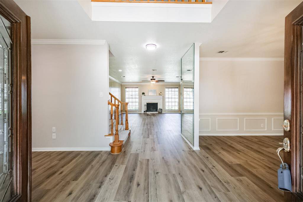 Upon entry, the double, glass-leaded front doors opens to freshly decorated home and gorgeous new flooring.