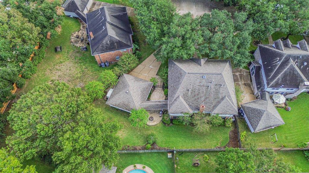 Aerial view of this cul de sac lot with mature trees at the front and rear of the home.