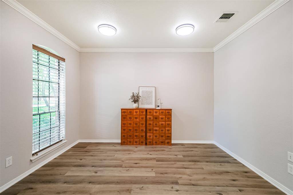 To the left of the Foyer is the Formal Livinf Room/Study. Freshly painted and new lighting provide the perfect Work From Home space, Formal Living Room or Children's Play Area.