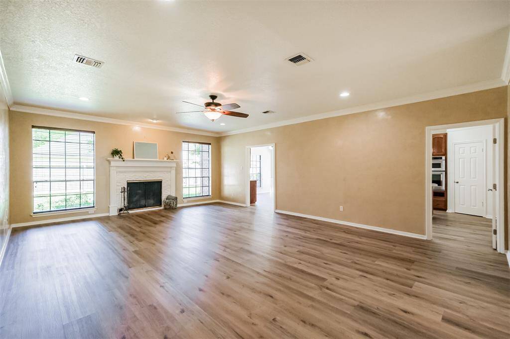 This generously sized room with a new custom stone surround fireplace and two large picture windows makes a wonderful family gathering spot.
