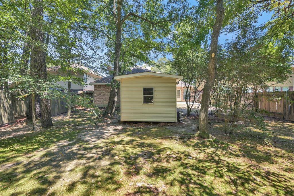 Maximize your garage space with the convenience of an on-site storage shed in the tranquil backyard.