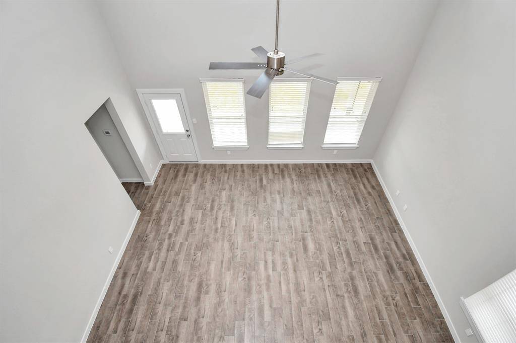 View of family room from landing above. Sample photo of completed home with similar floor plan. Actual colors and selections may vary.