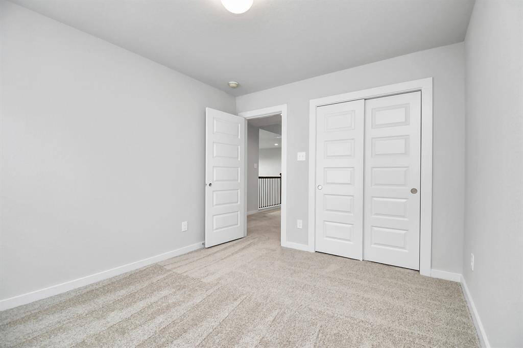 Generously sized secondary bedrooms, complete with spacious closets and soft, inviting carpeting. Sample photo of completed home with similar floor plan. Actual colors and selections may vary.