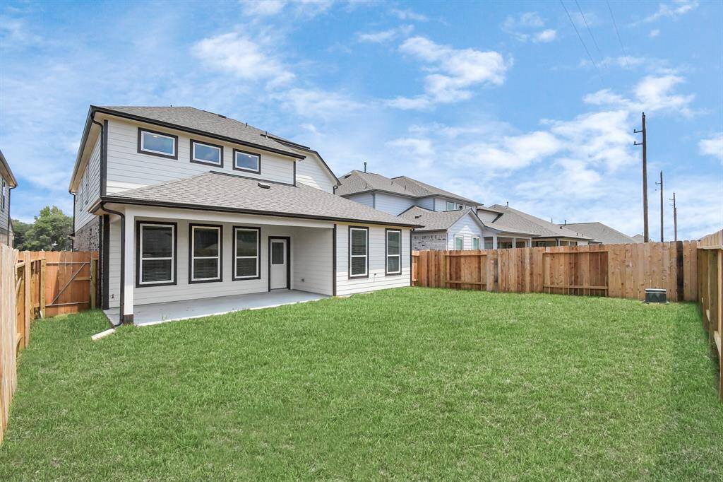 Backyard retreat, offering an abundance of space for kids to play and explore. The possibilities are endless in this outdoor haven, where the joy of open-air activities and family gatherings awaits. Sample photo of completed home with similar floor plan. Actual colors and selections may vary.