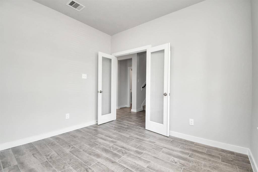 Another view of the home office, with French doors, at the forefront of the home. Sample photo of completed home with similar floor plan. Actual colors and selections may vary.
