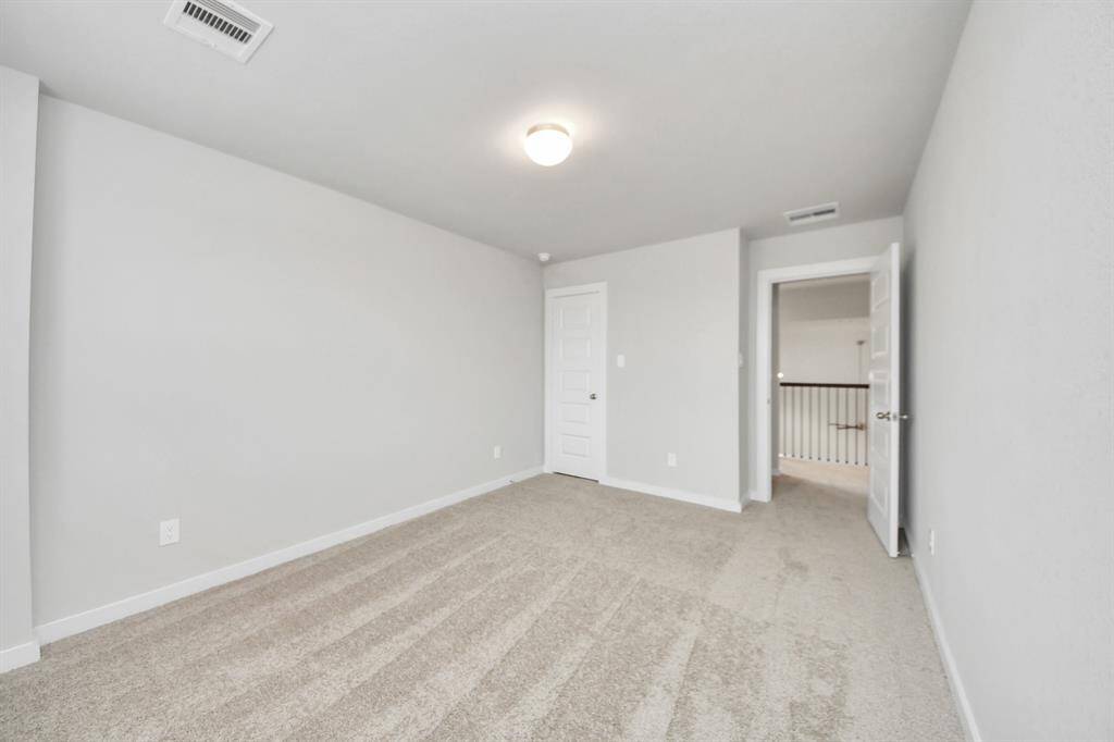 Generously sized secondary bedrooms featuring spacious closets, soft and inviting carpeting underfoot, large windows allowing plenty of natural light, and the added touch of privacy blinds for your personal retreat. Sample photo of completed home with similar floor plan. Actual colors and selections may vary.
