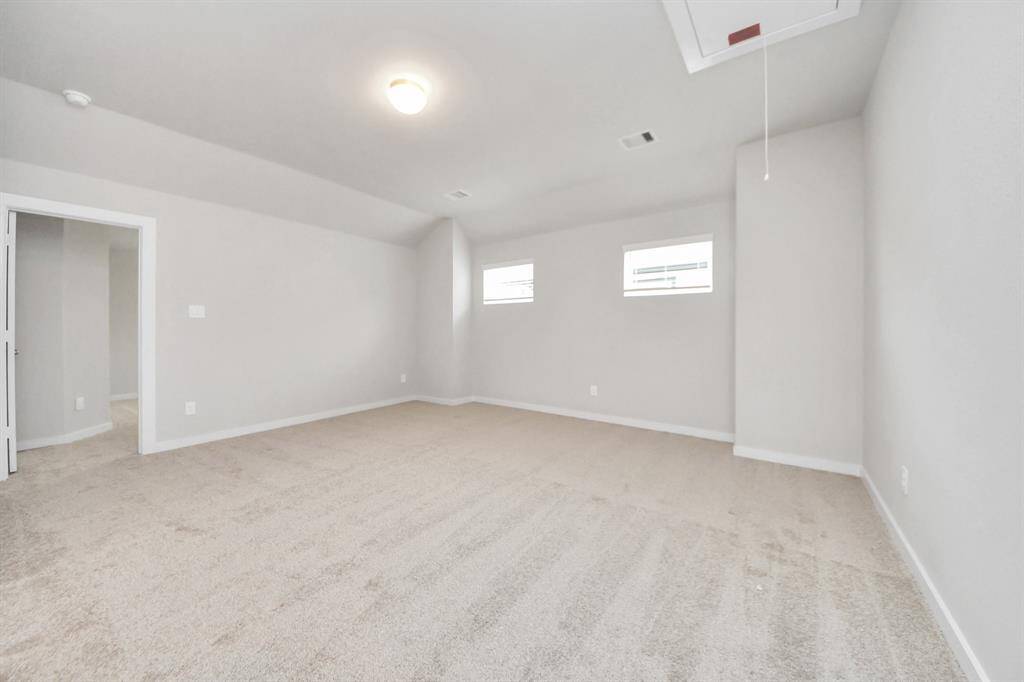 Come upstairs and enjoy a day of leisure in this fabulous game room! This is the perfect hangout spot or adult game room! Features plush carpet, high ceilings, custom paint and windows for plenty of natural light. Sample photo of completed home with similar floor plan. Actual colors and selections may vary.