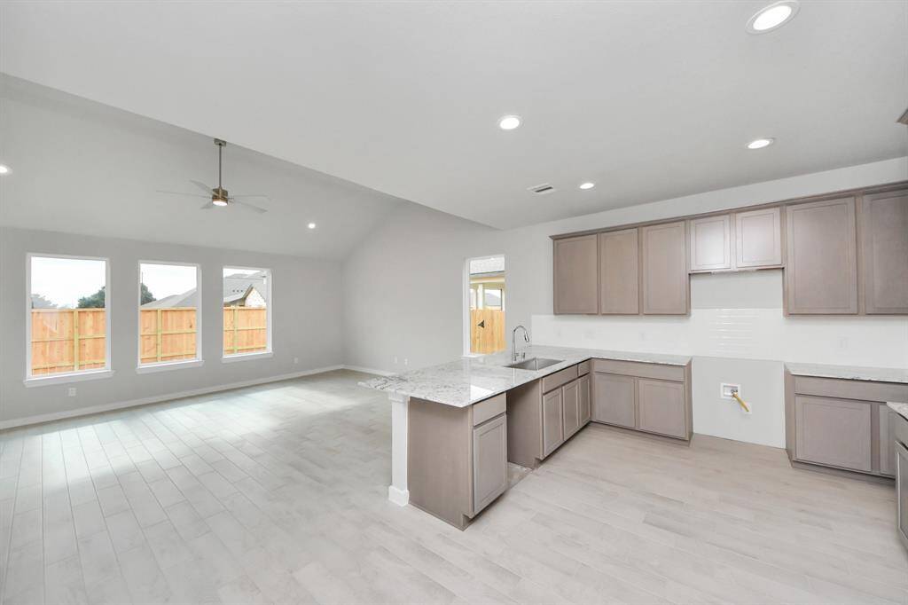 The kitchen is a culinary haven, featuring granite countertops, a tile backsplash, stainlesssteel appliances, and 42” upper cabinets. Sample photo of completed home with similar floor plan. Actual colors and selections may vary.