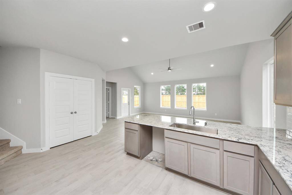 All this opens up to the expansive family room, creating a perfect hub forgatherings. Sample photo of completed home with similar floor plan. Actual colors and selections may vary.