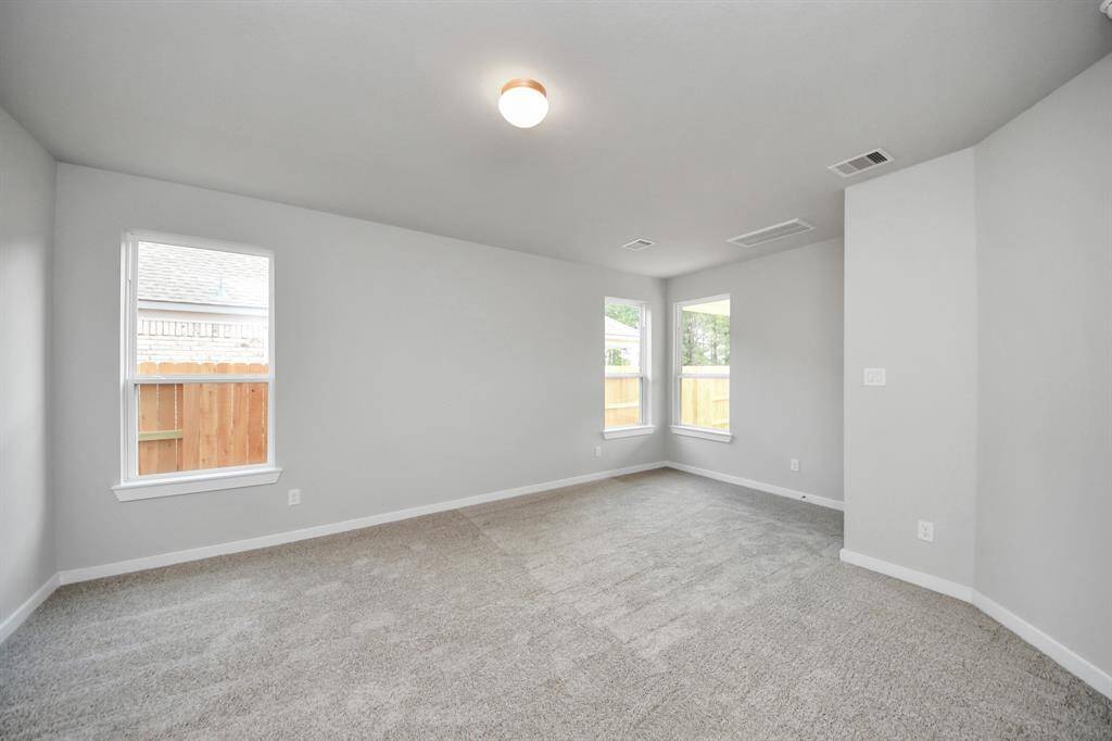 Retreat to the luxurious primary suite, your perfect escape for unwinding after a long day. Sample photo of completed home with similar floor plan. Actual colors and selections may vary.