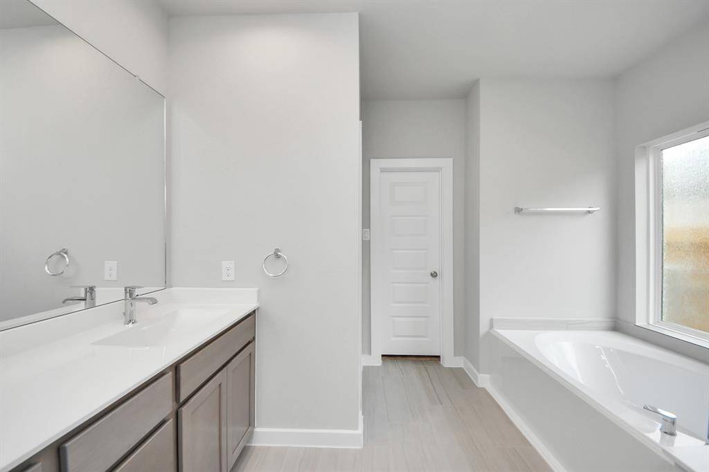 Indulge in a spa-like retreat within the confines of this primary bathroom. Sample photo of completed home with similar floor plan. Actual colors and selections may vary.