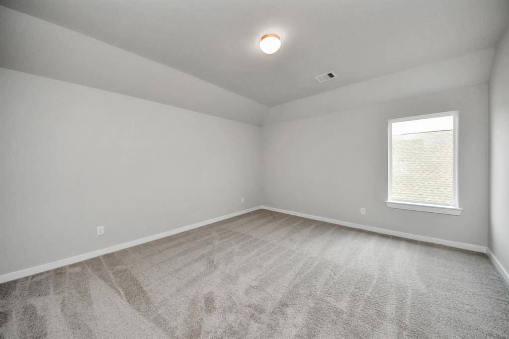 Ascend to relaxation in this fantastic game room! Ideal for both casual gatherings and adultgaming, it boasts plush carpet, lofty ceilings, custom paint, and ample windows for abundantnatural light. Sample photo of completed home with similar floor plan. Actual colors and selections may vary.