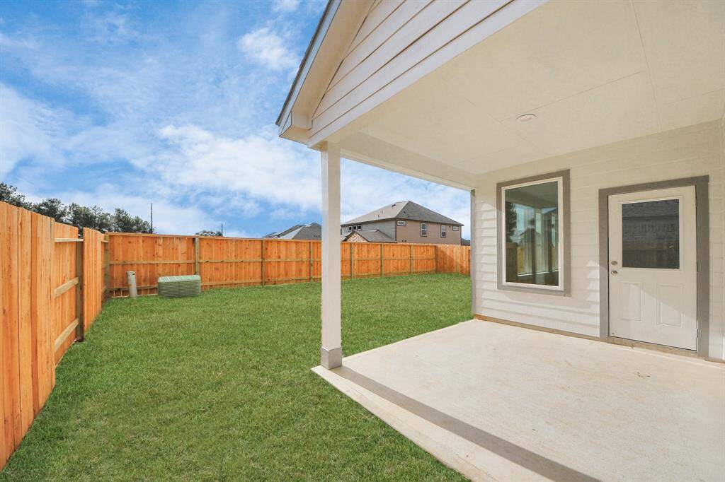 Experience outdoor living at its finest on this expansive covered patio,thoughtfully designed for BBQs and delightful outdoor dining. Sample photo of completed home with similar floor plan. Actual colors and selections may vary.