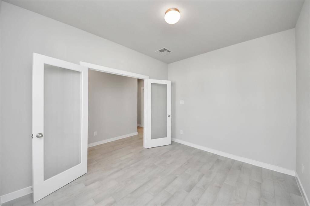 Experience the perfect blend of sophistication and warmth in this home office,boasting elegant wood-look tile flooring and flooded with natural light fromexpansive windows and French doors. Sample photo of completed home with similar floor plan. Actual colors and selections may vary.
