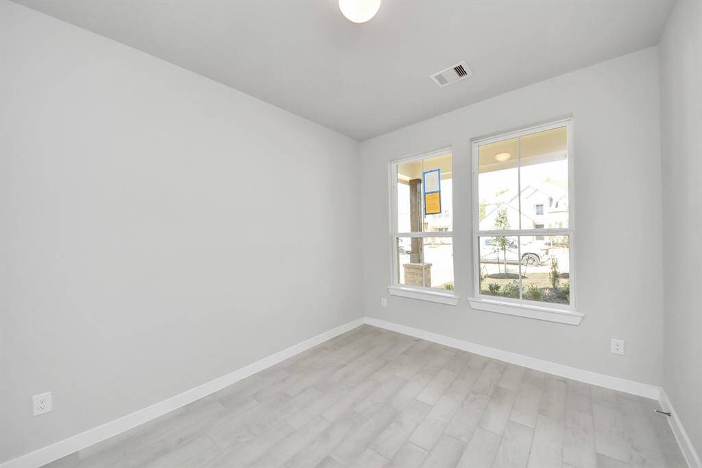 Step into the inviting home office, where elegant tile flooring adds a touch of freshnessand comfort to the workspace. Natural light pours through the window, creating aninspiring environment for productivity and focus. Sample photo of completed home with similar floor plan. Actual colors and selections may vary.